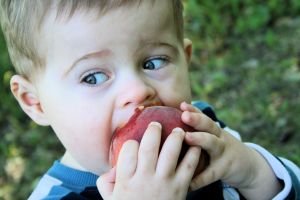 little-boy-eating-a-peach-1-1098258-m